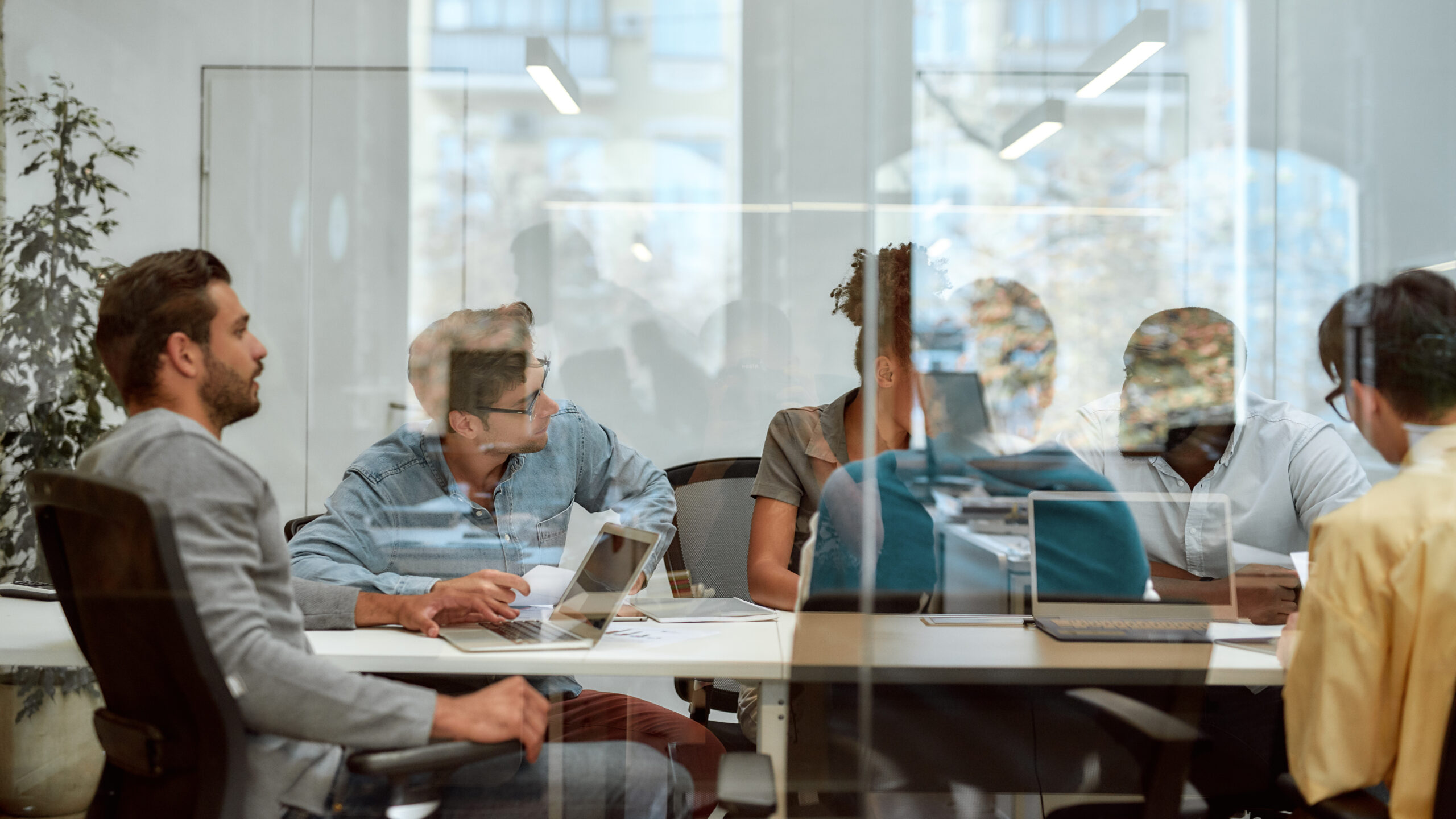 people talking at a table in a conference room