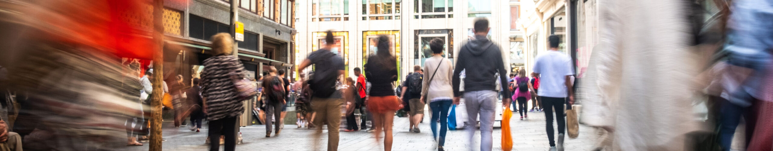 Motion blur of people walking in a retail area