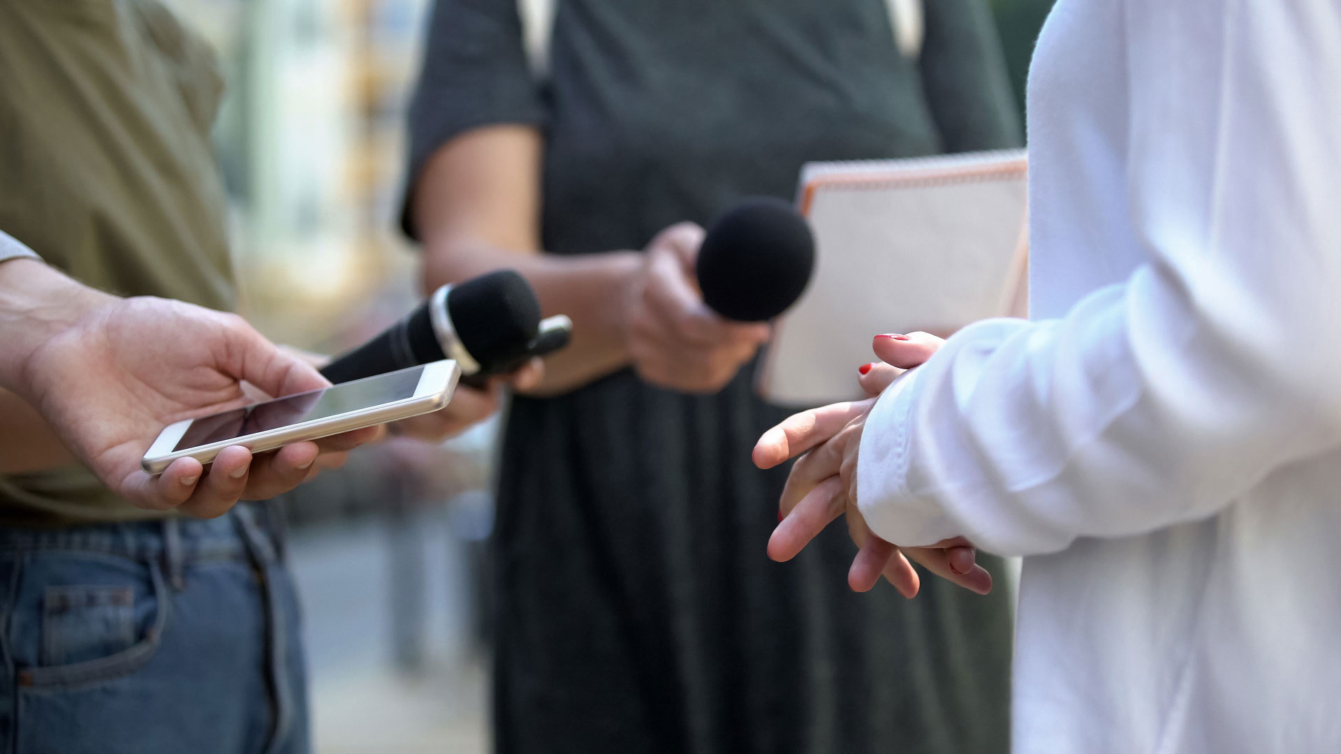 microphones and iphone taking statement at press release