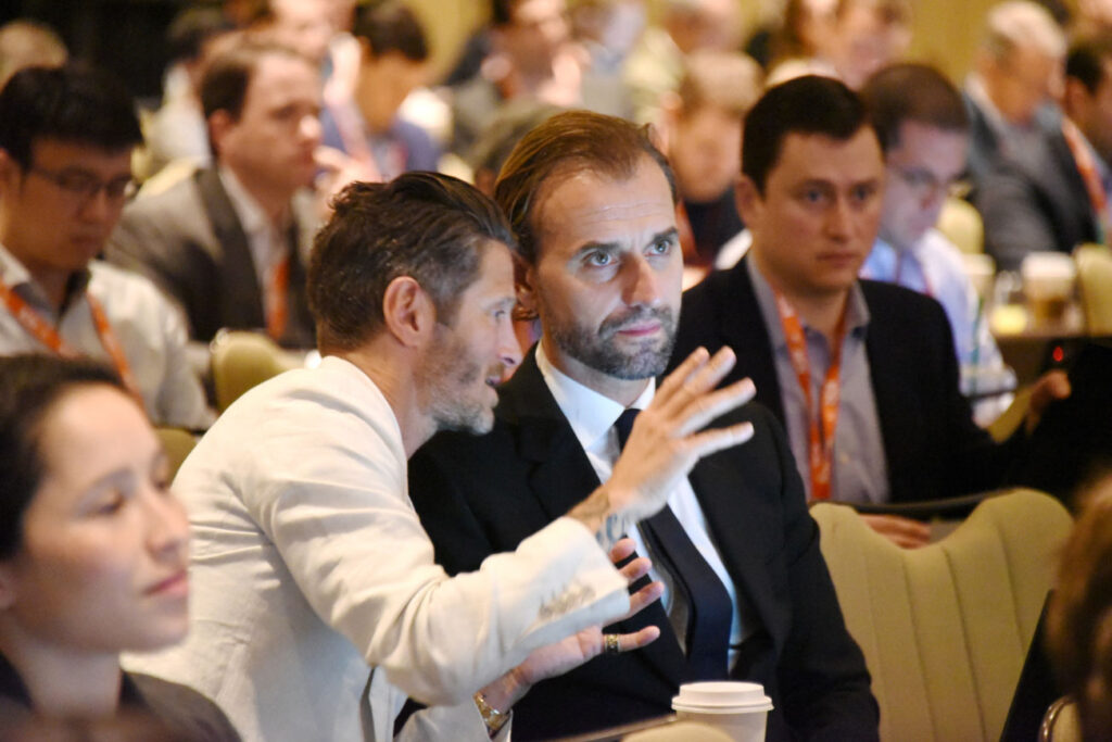 Two audience members at the ICR Conference in discussion during a session