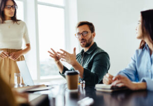 Man speaking with his hands in a small group meeting