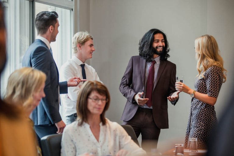 Group of analysts talking at a networking event