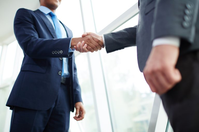 investors shaking hands making deal