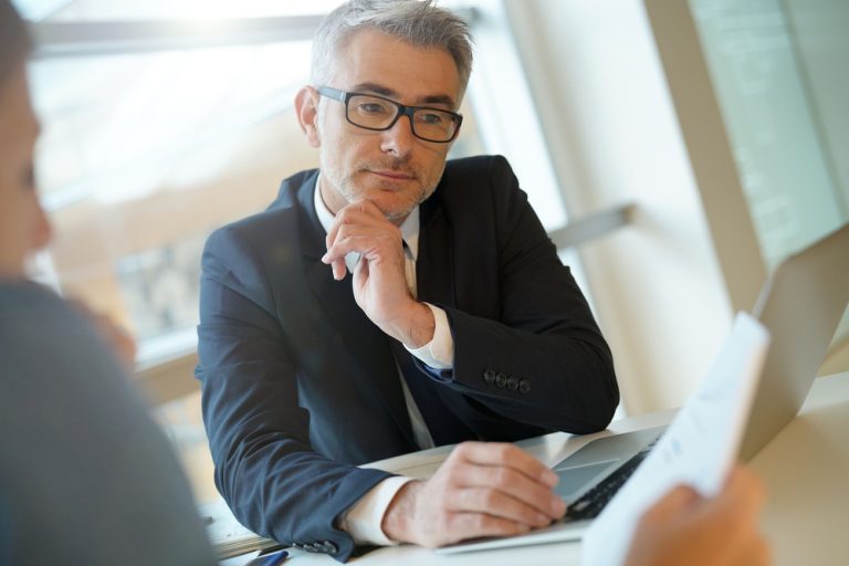 man reviewing computer