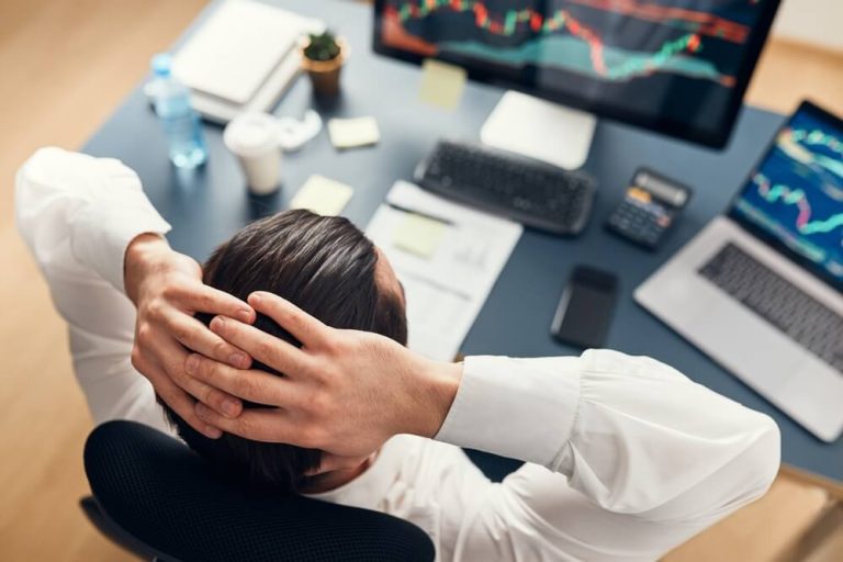 businessman looking stressed watching stock fluctuations economic downturn