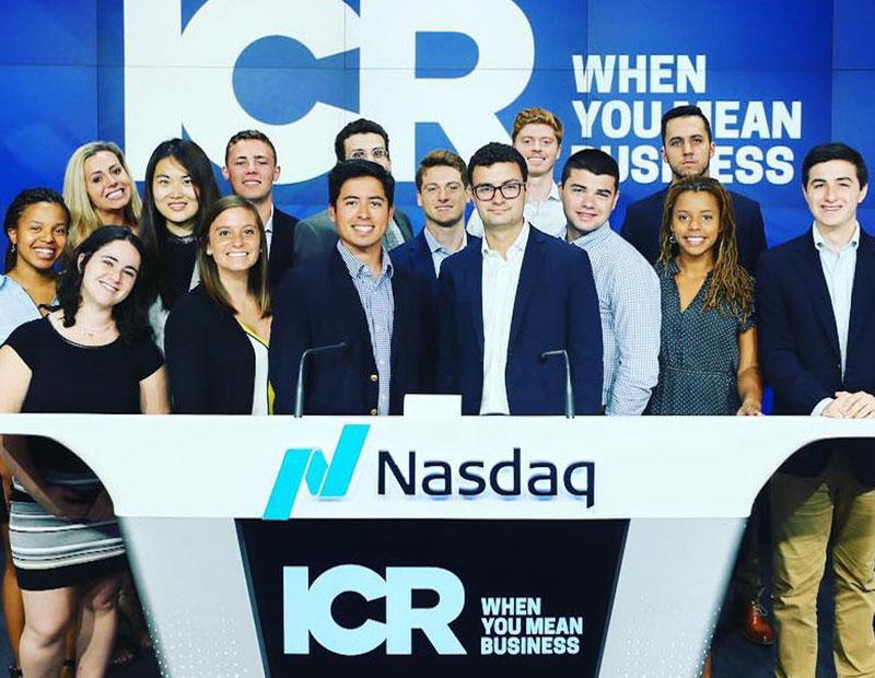 ICR colleagues in front of Nasdaq podium