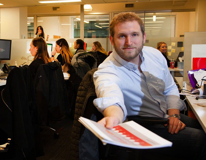 ICR employee handing paper towards camera