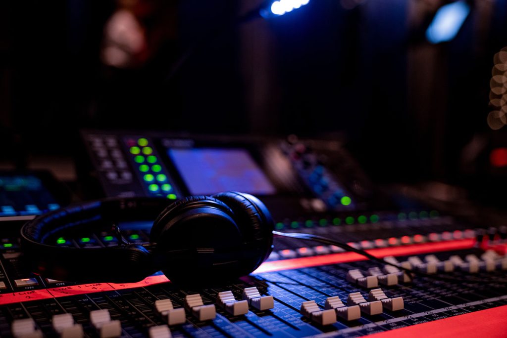 Headphones on top of a sound mixing board