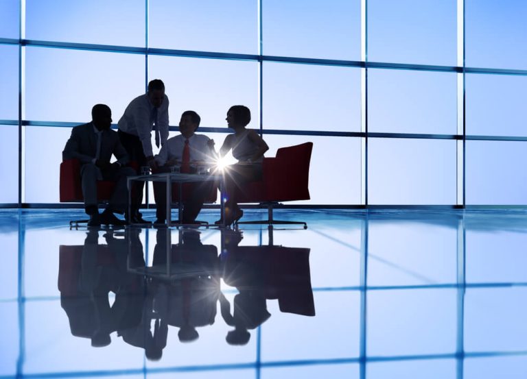 business group meeting silhouette in large room with big windows