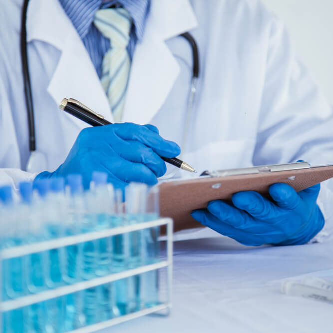 doctor writing info about clinical trial on clipboard