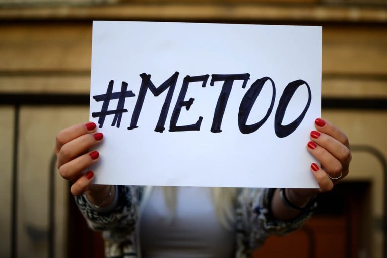 person holding up #MeToo movement sign