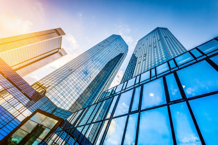 Perspective image from below of city buildings against blue sky