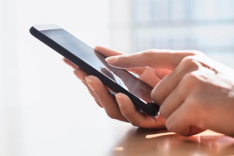 Person using cell phone close up on hand