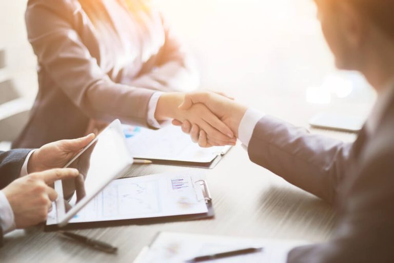 Handshake at meeting table