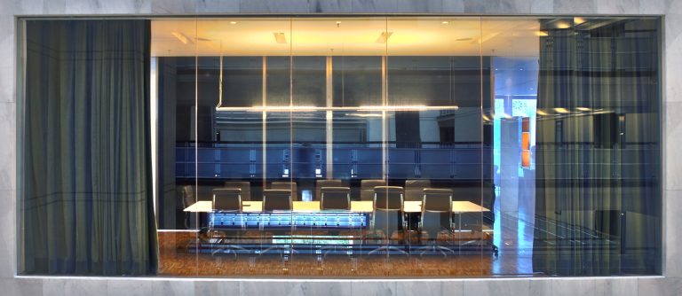 view of empty conference room from the exterior of a building|Leather office chairs at a wooden conference table