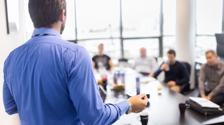 man leading business meeting