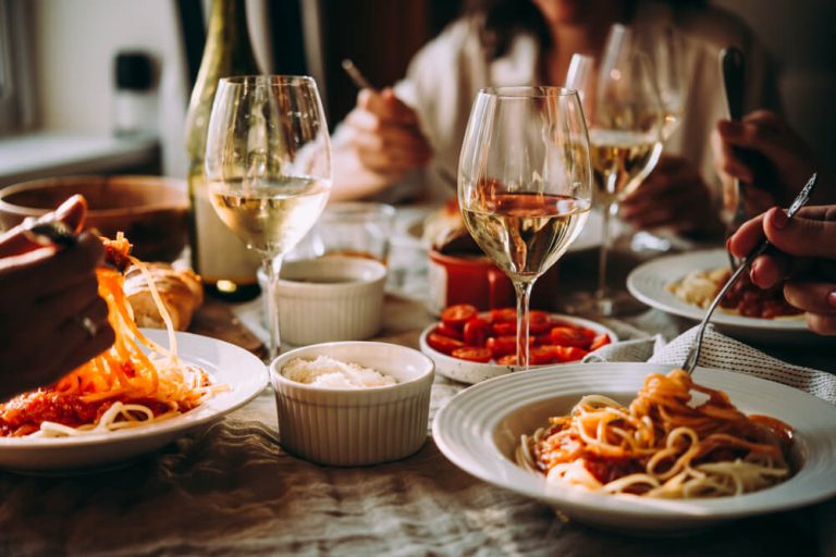 Restaurant table with meals and wine glasses