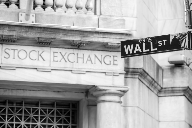 Wall St sign in front of NY Stock Exchange